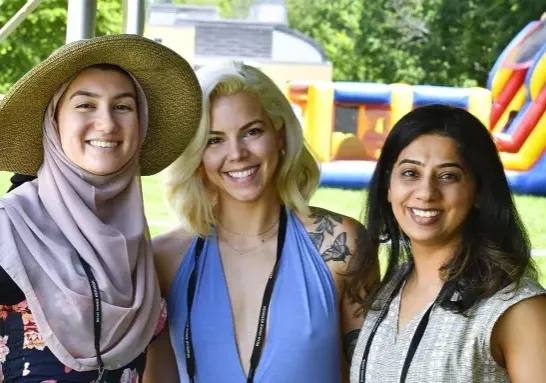 Three alumnae at an event