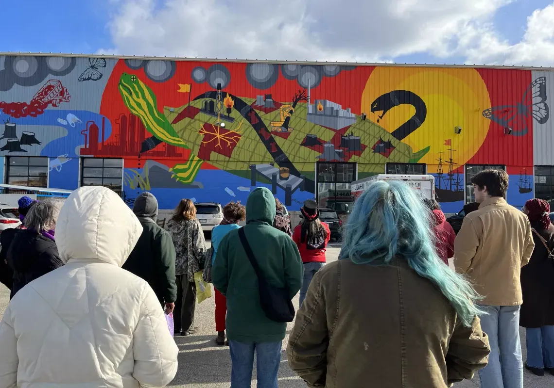 Students looking at Climate Justice Mural